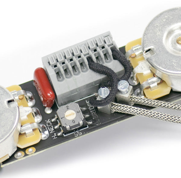 A close up image of the ObsidianWire custom universal wiring harness for Telecaster showing the method of install for vintage braided pickup wires