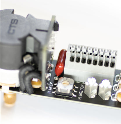 an ObsidianWire HH &amp; HS  Custom Universal  Tele Wiring Harness is shown on a clear cut white background. The image is zoomed in in the small components of the harness.